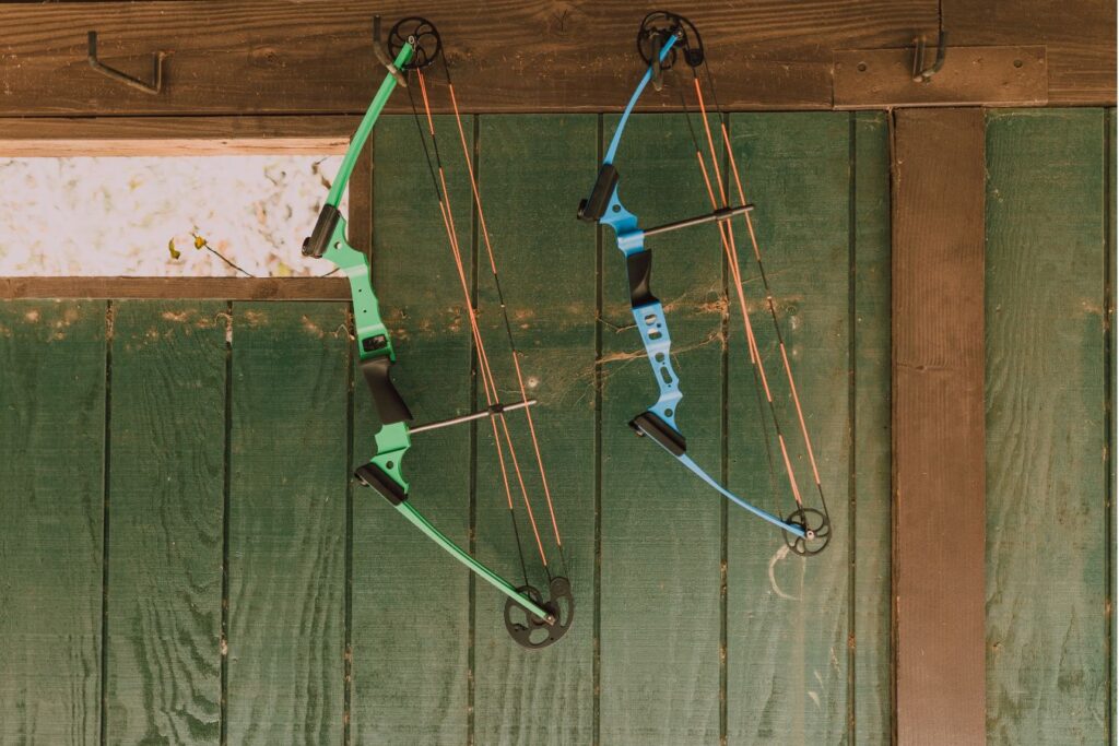 There are two compound bows hanging
