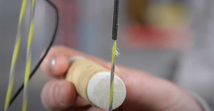 How to Clean a Compound Bow; apply bowstring wax to the string